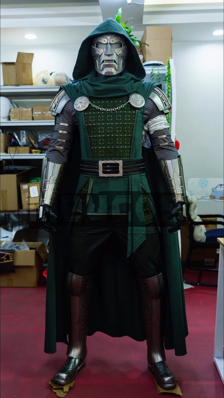 A person dressed in a detailed Doctor Doom costume with a silver mask and green hooded cloak.